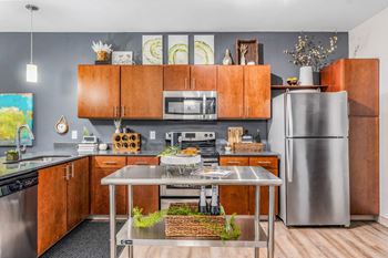 a kitchen with stainless steel appliances and wooden cabinets